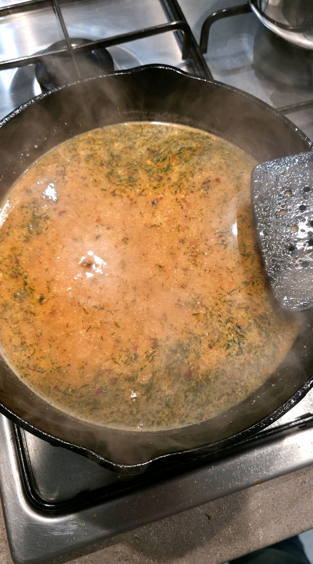 Prawn linguine sauce simmering gently in a saucepan
