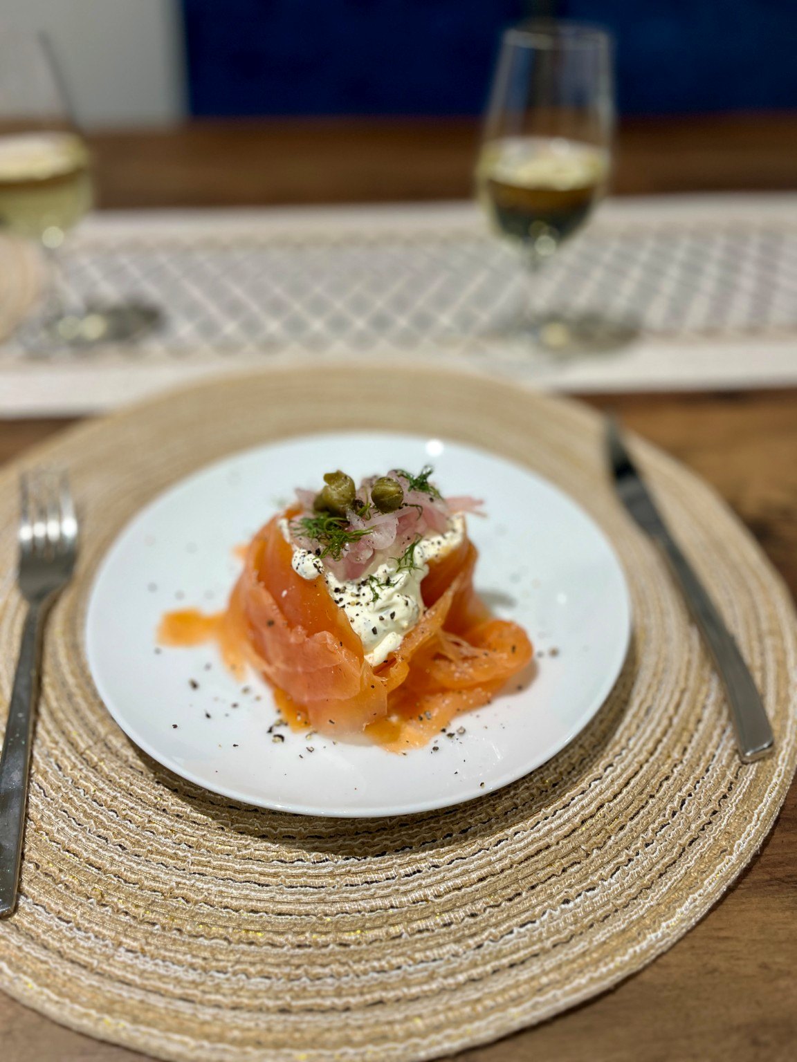 Close-up of original smoked salmon starter with dill cream and pickled shallots