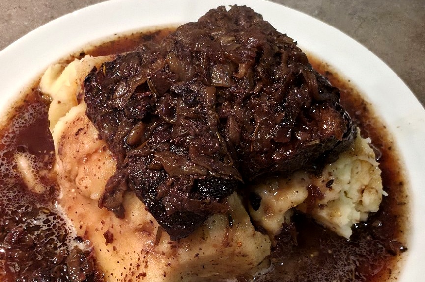 Home-cooked red wine Wagyu short ribs on garlic mash with rich gravy, photographed after serving